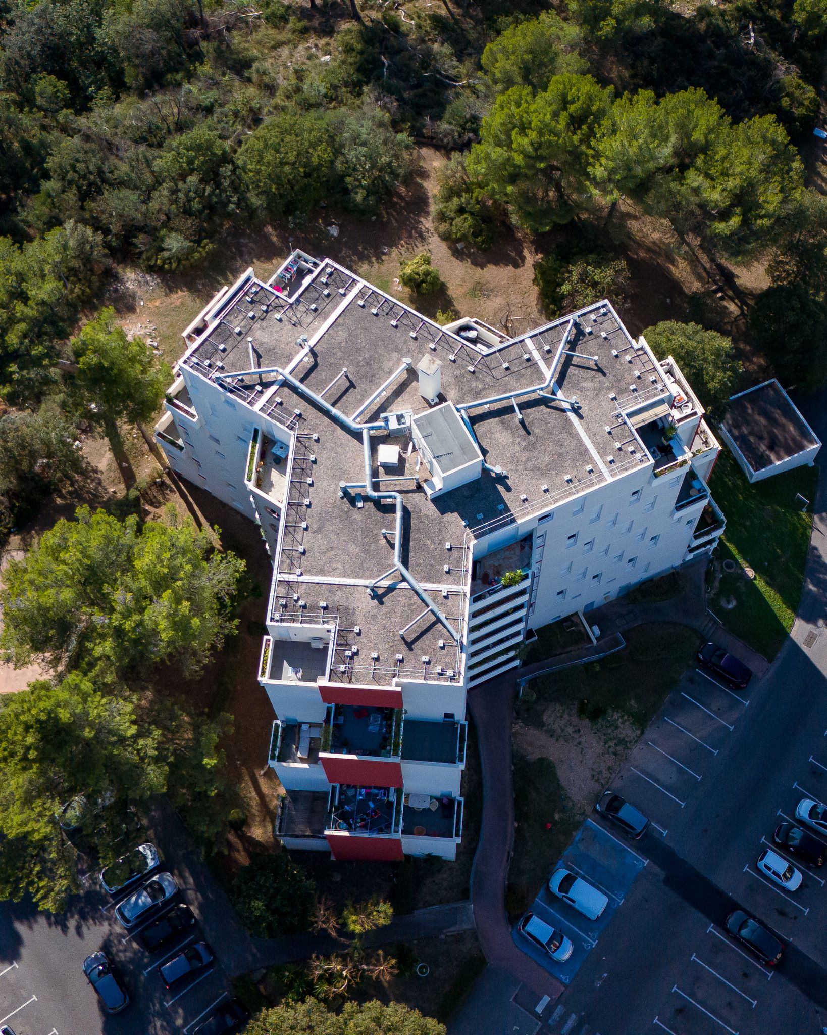 Aerial view of a modern apartment complex surrounded by greenery in Marseille, France.