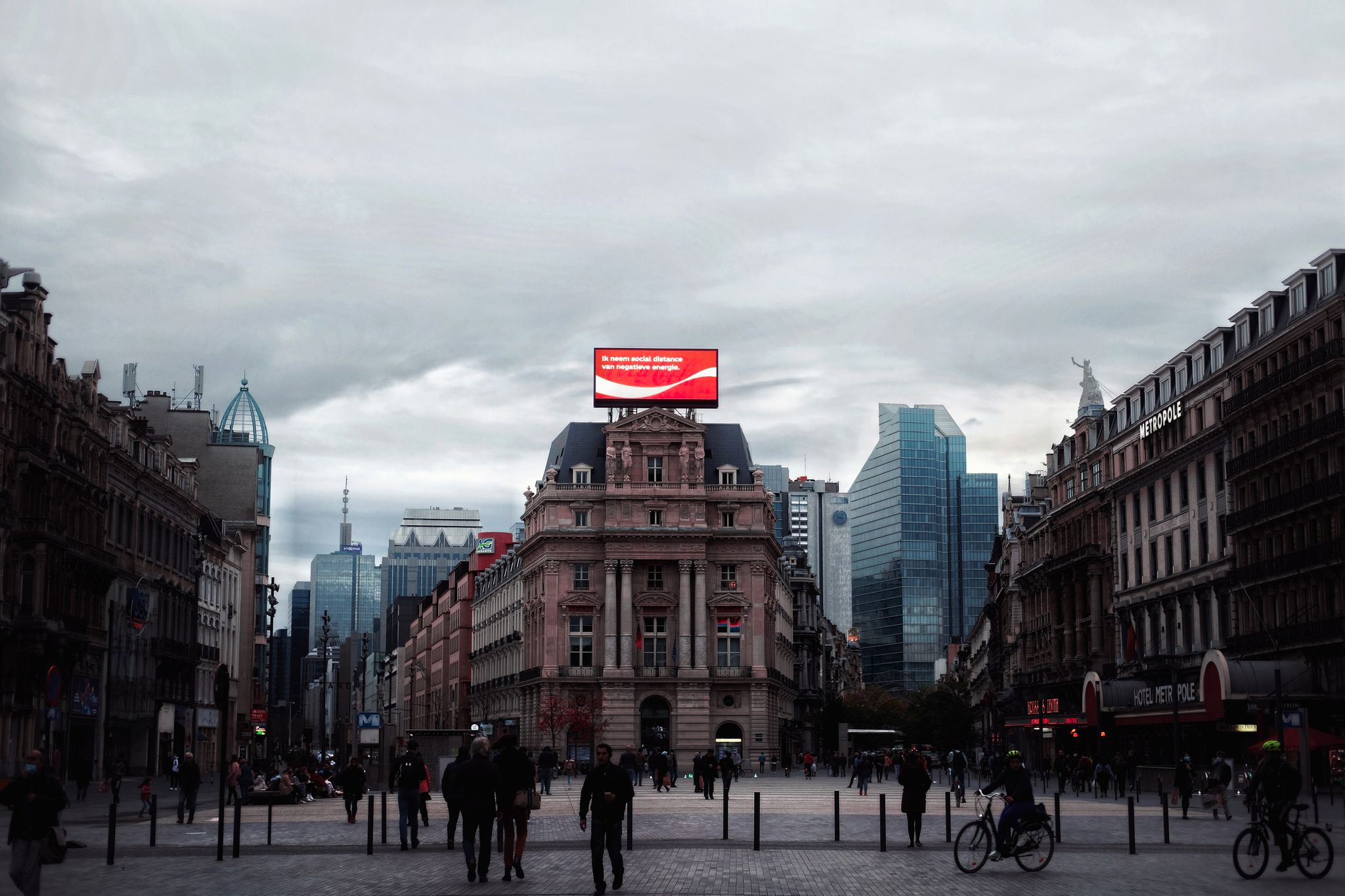 Dramatic cityscape featuring a blend of historical and modern buildings with pedestrians and cyclists.